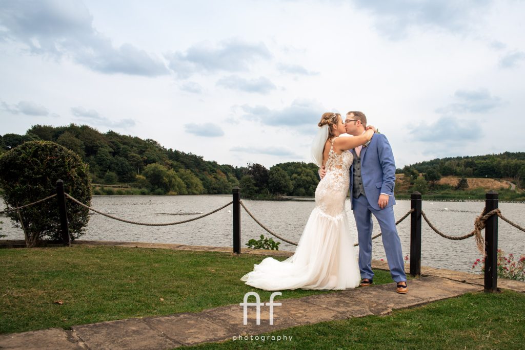 Bride and groom having the couples portraits on the island at Waterton Park Hotel