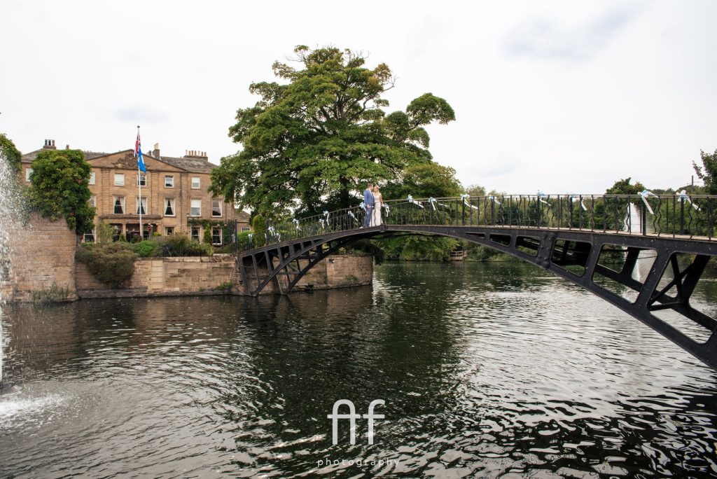 Bride and groom on the stone bridge at Waterton Park Hotel, Wakefield