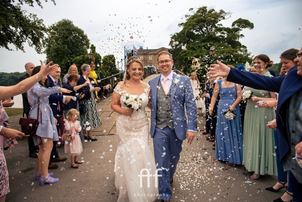 Bride and Groom having confetti thrown at Waterton Park Hotel