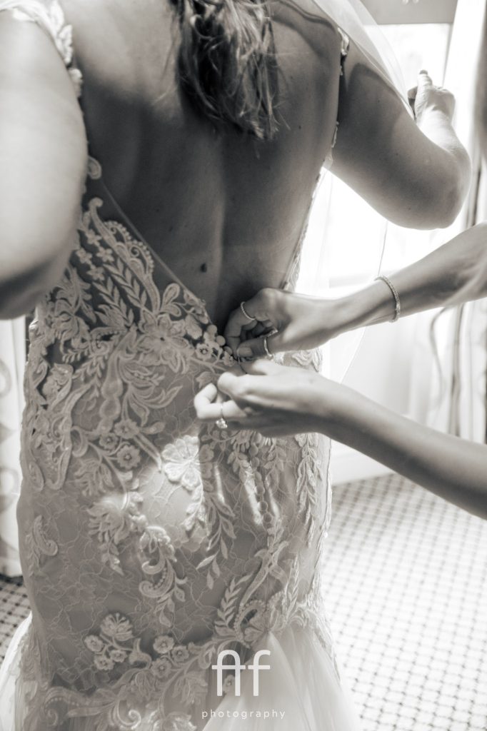 Bride getting into her Perfect Daze wedding dress