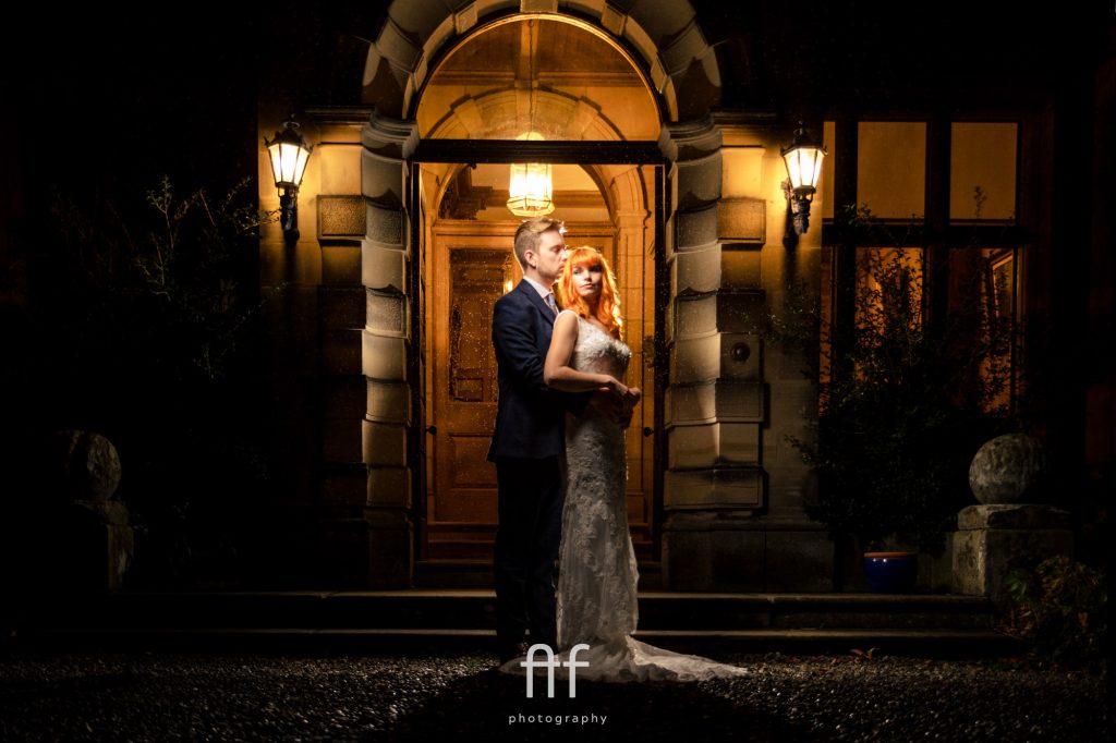 what to do if it rains on your wedding day photography - bride and groom having a portrait in the rain